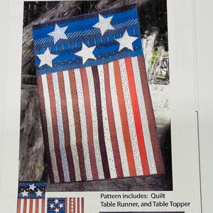 May include: A quilt pattern titled "Freedom" by Nellie's Needle. The design features a quilt with a blue top adorned with white stars and red and white striped sections. The pattern also includes a table runner and table topper.