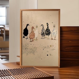 May include: A framed art print depicting six decorative ducks in various patterns and colours, including black, brown, white, and floral designs. The artwork is set against a beige background with ink splatters and floral accents, framed in light brown wood.