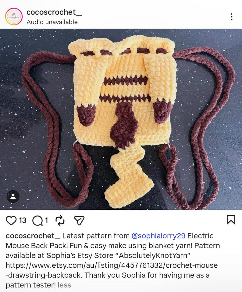 May include: A yellow and brown crochet drawstring backpack featuring a square body with horizontal brown stripes, two thick brown braided straps, and a prominent zigzag-shaped tail attached to the center of the front panel.