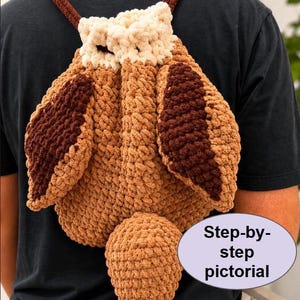 May include: A crochet pattern for a backpack shaped like an owl, featuring thick, textured yarn in shades of cream, light brown, and dark brown. The design includes prominent ear tufts, large wings, and a tail. Text reads PDF CROCHET PATTERN and Step-by-step pictorial.