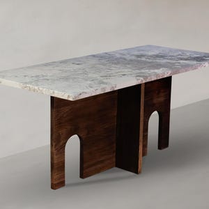 May include: A rectangular dining table featuring a polished white and grey marble top with natural veining. The base is constructed from dark brown wood, consisting of two vertical panels, each featuring a distinct arched cutout design.