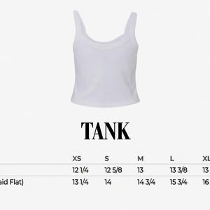 May include: White tank top with a scoop neck and spaghetti straps. The word "TANK" is printed in bold, black letters below the top. Size chart includes body length and chest width measurements in inches for sizes XS to 2XL.