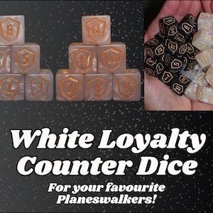 May include: White Loyalty Counter Dice with gold numbering and shield designs. The image shows a stack of white dice and a handful of black dice. The text on the image reads "White Loyalty Counter Dice".