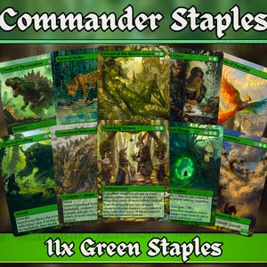 May include: A collection of eleven green Commander Staples Magic: The Gathering cards. The cards feature various fantasy art, including a dinosaur, a leopard, and a phoenix. The text "Commander Staples" and "11x Green Staples" are displayed.