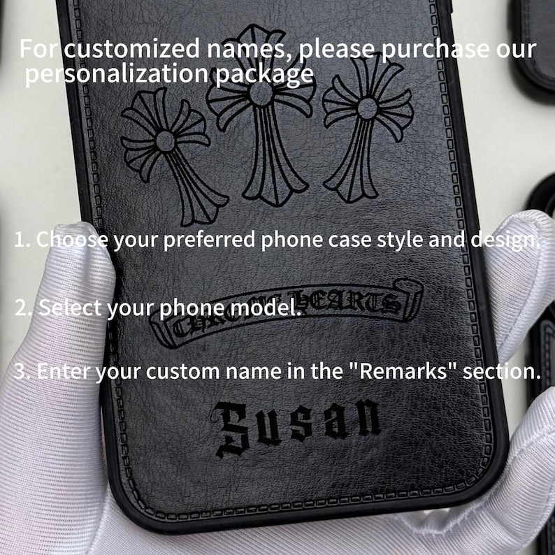 May include: Black phone case with a decorative cross design and the name "Susan" embossed on the front. The case has a textured surface and includes instructions for customization. The text on the case reads "CHROME HEARTS".