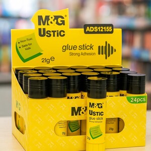 May include: A display box of M&G USTIC glue sticks. The box is yellow with black text and graphics, including the words "glue stick" and "Strong Adhesion." Each glue stick is 21g. The box contains 24 pieces and is labeled "Safe for Kids."
