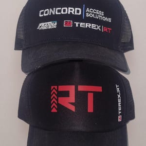 May include: Two black trucker hats. The top hat has the text "CONCORD ACCESS SOLUTIONS" and "TEREX|RT" in white and red. The bottom hat has a red "RT" logo and "TEREX|RT" text.