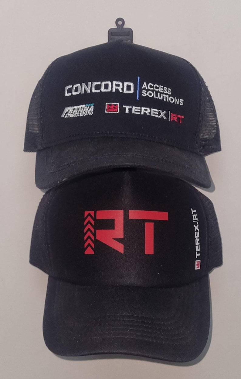 May include: Two black trucker hats. The top hat has the text "CONCORD ACCESS SOLUTIONS" and "TEREX|RT" in white and red. The bottom hat has a red "RT" logo and "TEREX|RT" text.