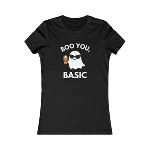 May include: Black t-shirt with the phrase "Boo You, Basic" and a graphic of a ghost wearing sunglasses and holding a coffee cup. The ghost is white, the sunglasses are black, and the coffee cup is orange.