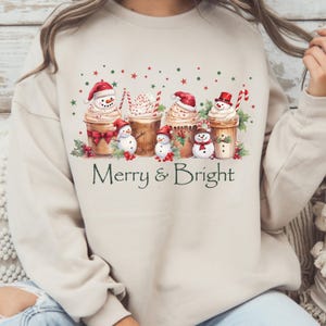 Winter Holiday Sweatshirt Christmas Coffee Design Festive Seasonal Apparel Merry Bright Theme Snowman Cup Illustration Whipped Cream Detail Candy Cane Accent Holly Berry Decoration Comfortable Cotton Blend Perfect Christmas Gift Holiday