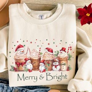 Coffee Themed Sweatshirt Christmas Holiday Design Festive Winter Apparel Merry Bright Message Snowman Whipped Cream Decoration Holly Berry Accent Candy Cane Detail Holiday Season Essential Cotton Blend Comfort Perfect Gift Idea Christmas