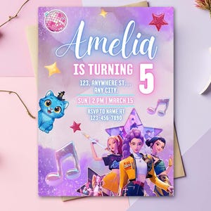 May include: A birthday party invitation with the name "Amelia" in a cursive font. The invitation includes the text "IS TURNING 5", event details, and a phone number. The design features illustrations of a cat, stars, and musical notes.
