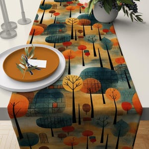 May include: A patterned table runner featuring a repeating design of trees and houses in orange, yellow, and teal. The runner's artistic design adds a vibrant touch to the table setting. A plate and a vase are on the table.