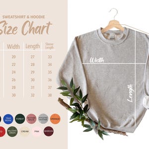 May include: A light gray sweatshirt hanging on a wooden hanger, with a size chart to the left. The chart lists sizes S to 3XL, with width, length, and sleeve length measurements in inches. Color swatches are at the bottom.