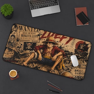 Może przedstawiać: Prostokątna podkładka na biurko z nadrukiem graficznym przedstawiającym Monkey D. Luffy'ego z One Piece. Projekt zawiera plakat z listem gończym, statek piracki i japoński tekst. Paleta kolorów składa się z odcieni beżu, czerni i czerwieni.