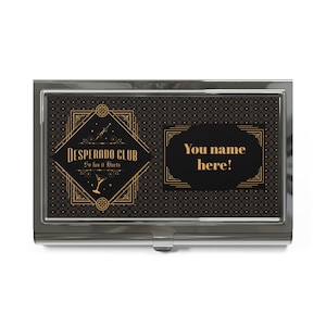 May include: A silver business card holder with a black and gold art deco design. The left side features the text "Desperado Club" and the phrase "So fun it Hurts". The right side has the text "You name here!" in gold.