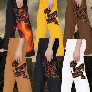 May include: Collection of pajama pants in black, yellow, brown, tan, black, and white. Each pair features the text "THEY WILL NOT BREAK ME" on a banner. One pair has a flame graphic.