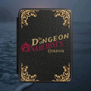 May include: A black rectangular book cover with a textured surface, featuring gold ornate corner flourishes. The text reads The Dungeon Anarchist's Cookbook, with the word Anarchist in red and a red anarchy symbol integrated into the letter D.
