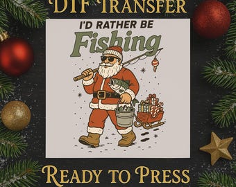 May include: DTF transfer featuring Santa Claus with sunglasses, holding a fishing rod and a fish, with the text "I'd Rather Be Fishing." Santa is wearing a red suit and carrying a bucket and a sleigh of presents. The words "Ready to Press" are also visible.