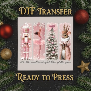 May include: A DTF transfer design featuring a pink Nutcracker, ballerina, Christmas tree, and mouse in a coat. The text "It's the most wonderful time of the year" is included. The words "DTF TRANSFER" and "READY TO PRESS" are also present.