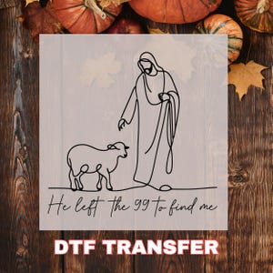 May include: Black line art DTF transfer featuring a figure and a lamb with the text "He left the 99 to find me." The design is set against a light gray background with a wooden texture and autumn decorations.