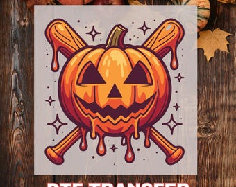 May include: A Halloween-themed DTF transfer featuring a grinning jack-o'-lantern with crossed baseball bats. The pumpkin is orange with a carved face and dripping orange goo. The text "DTF TRANSFER" is at the bottom.