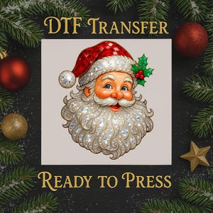 May include: DTF Transfer image featuring Santa Claus with a red hat and a diamond-studded beard. The image includes the text "DTF TRANSFER" and "READY TO PRESS". Festive Christmas ornaments and pine branches surround the image.