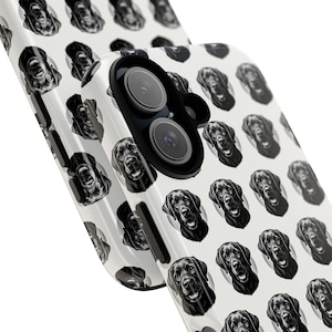 May include: A white phone case featuring a repeating pattern of black Labrador Retriever portraits. The case has a black camera module and a glossy finish. The design showcases the dog's face in a detailed, artistic style.