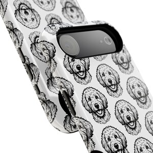 May include: White phone case featuring a repeating pattern of black and white dog illustrations. The case has a camera cutout and a glossy finish. The design showcases a playful and artistic aesthetic, perfect for dog lovers.