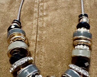 Elegant gray, black, gold and crystal necklace on a silver chain
