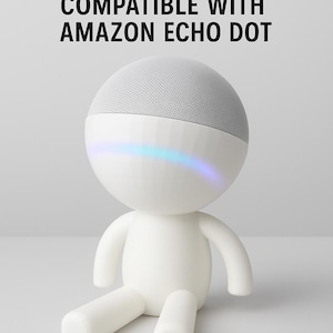 May include: White figure stand compatible with Amazon Echo Dot. The stand is shaped like a person with a round head and a gray speaker. The figure has a blue and purple light across the face. Text on the top says "FIGURE STAND COMPATIBLE WITH AMAZON ECHO DOT."