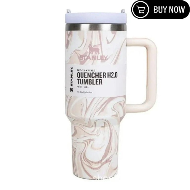 May include: A Stanley Quencher H2.0 Tumbler with a white lid and handle. The stainless steel tumbler features a marble-like pattern in shades of white and pink. The text "QUENCHER H2.0 TUMBLER" is printed on the front. It holds 40 oz.
