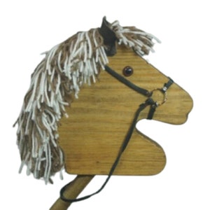 May include: Wooden toy horse head with a brown and white mane and a black leather bridle. The horse head is attached to a wooden stick.