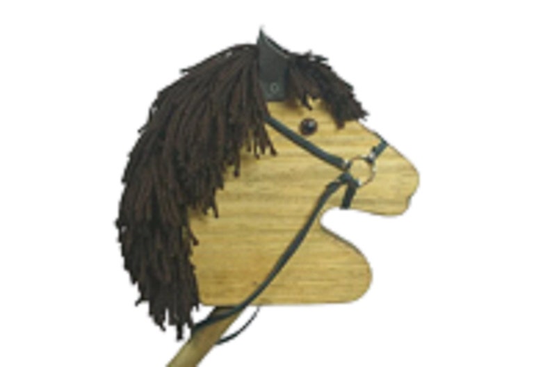 May include: A wooden toy horse head with a brown yarn mane and a black leather bridle. The horse has a brown wooden body and a black leather strap for holding.