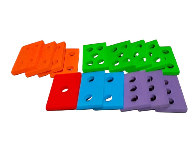 May include: A set of colorful foam building blocks with holes. The blocks are orange, green, red, blue, and purple.