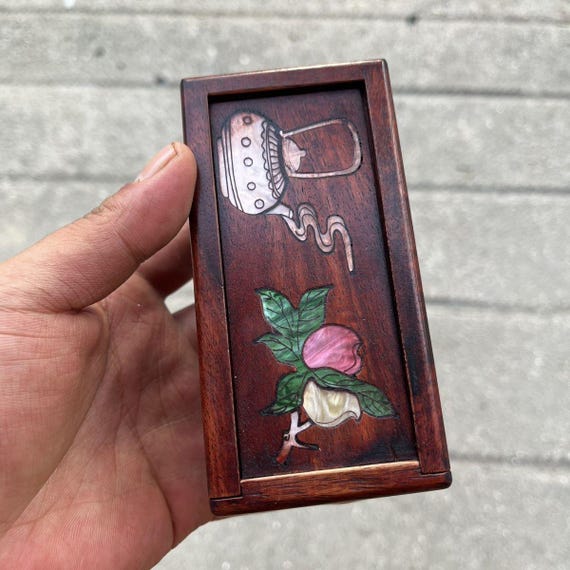 Rosewood with mother-of-pearl inlay and a hidden opening mechanism — this is the kind of box that makes people stop and ask "how do you open it?"