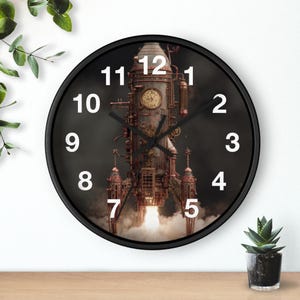 May include: A round black wall clock featuring a steampunk rocket ship design. The clock face has white numerals and black hands. The rocket is detailed with copper and bronze tones, with flames and smoke at the base.