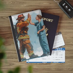 May include: A passport holder featuring a firefighter and a nurse high-fiving. A dark blue passport, plane tickets, and a car key are also visible. The passport holder is black and white.