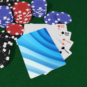 May include: Poker chips in black, red, and blue are stacked on a green surface, alongside a hand of playing cards. The cards show the ten of hearts, ten of diamonds, and ten of spades, with a blue patterned card in the foreground.