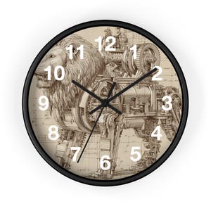 May include: A round wall clock with a black frame. The clock face features a detailed sepia-toned illustration of a lion's head and body integrated with mechanical gears and machinery. White numerals mark the hours.