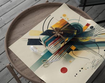 May include: A wrapped gift with a brown ribbon sits on abstract art wrapping paper. The paper features a design with blue, yellow, and orange geometric shapes. A pair of scissors and a clear tape dispenser are also on the paper.