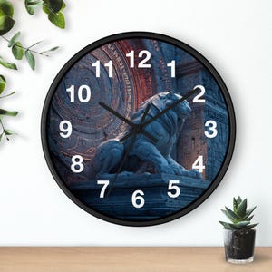 May include: A circular wall clock with a black surround. The clock face displays a blue and red background with a sculpted lion statue. White numerals mark the hours. The clock hands are black.