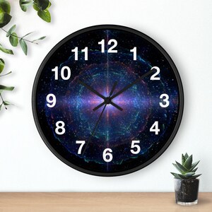 May include: A round wall clock with a black frame and a face featuring a vibrant space nebula design in shades of blue, purple, and green. The clock has large white Arabic numerals from 1 to 12 and thin black hour, minute, and second hands.