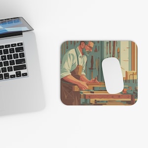 May include: A rectangular mousepad featuring an illustration of a carpenter working at a workbench. The carpenter is wearing an apron and glasses. A white computer mouse is on the right side of the mousepad. The background shows tools hanging on a wall.