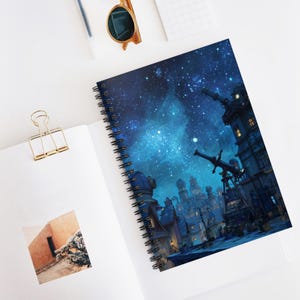 May include: Spiral-bound notebook featuring a vibrant illustration of a starry night sky with a cityscape. The cover art showcases a detailed depiction of buildings and telescopes under a celestial backdrop, perfect for note-taking or journaling.