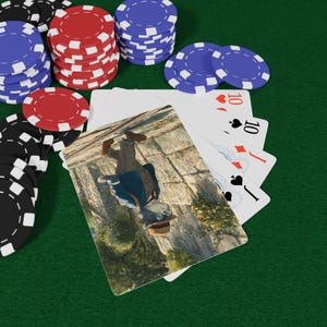 May include: A poker game setup featuring playing cards and poker chips on a green felt surface. The cards display the number 10 in various suits. Stacks of red, blue, and black chips are arranged, indicating a game of chance.