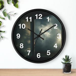 May include: A round wall clock with a black frame and a face featuring a photographic print of a rainy window view with dark, stormy clouds. The clock has large, bold white Arabic numerals from 1 to 12 and thin black hour, minute, and second hands.