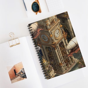 May include: Spiral-bound notebook with a steampunk clock tower design and airships. The cover features a detailed architectural illustration in beige, gold, and brown, with two clock faces. The notebook is open on a white surface with a gold paper clip and sunglasses.