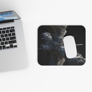 May include: A computer mouse and mousepad featuring a detailed, futuristic space station design. The mousepad is rectangular with rounded corners, and the mouse is white. The background is dark, highlighting the intricate details of the space station.