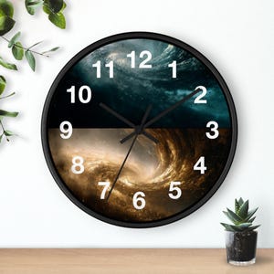 May include: A round wall clock with a black frame. The clock face is divided horizontally, with a dark blue and teal galaxy design on top and a golden galaxy design on the bottom. White numerals mark the hours.